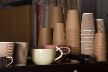 Ceramic and cardboard cups for takeaway coffee and tea in small caffee