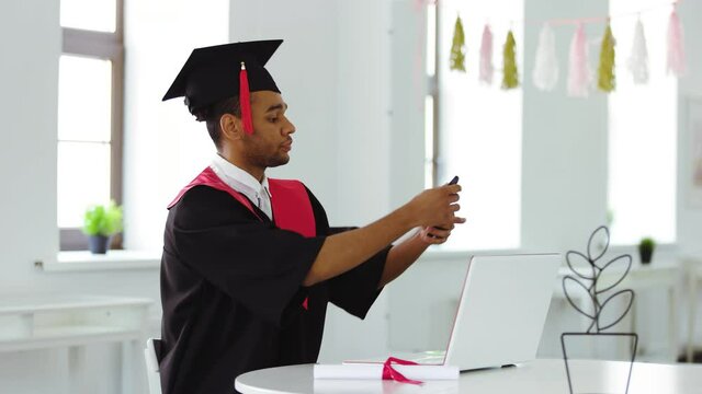 Virtual graduation ceremony. Black Graduate in quarantine. Graduates in square mortarboard communicates via video call