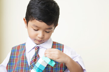 Cute Asian boy about 3 years old wearing a school uniform he has a happy face smile concept. 