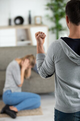 man beating helpless woman at home