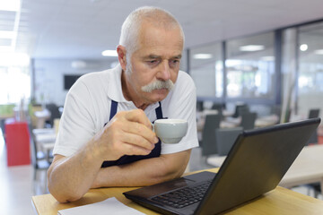 senior man holding a cup of coffee