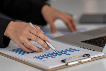 Close up of Businesswoman hands hold documents with financial statistic stock photo,discussion and analysis data the charts and graphs. Finance concept	