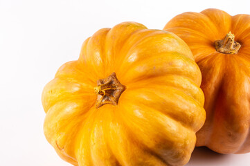 Two whole fresh orange big pumpkin on white background, closeup. Organic agricultural product, ingredients for cooking, healthy food vegan.