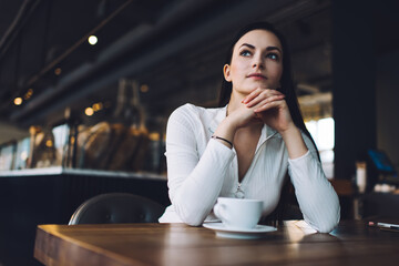 Thoughtful woman with cup of coffee