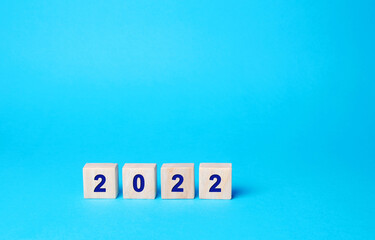 Wooden blocks with the inscription 2022. Setting goals and objectives for the new year. Planning, business management and strategy concept. Trends and ideas. Vision.