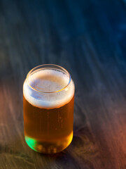 Creative Fashion Beer Glass in the shape of a can. Light beer lager on a dark table