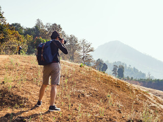 hiker photographing golden rice terraces after the harvest season.