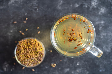 Hot healthy tea with fresh birch buds in spring, close up, top view