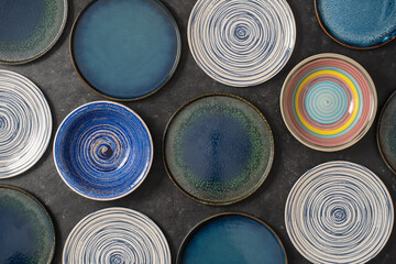 Many empty plate on black background, close up