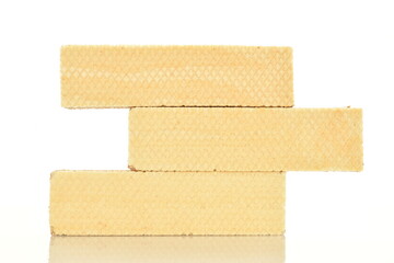 Three sweet vanilla waffles, close-up, isolated on white.