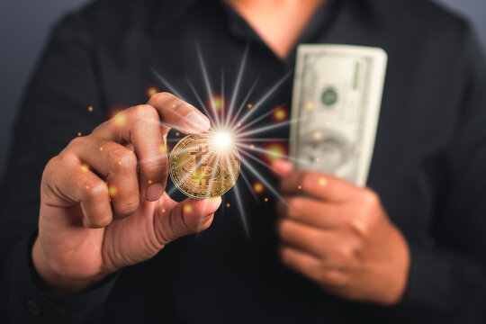 Successful businessman holds a bitcoin coin and US banknote in his hand. Bitcoin a symbol of cryptocurrency - electronic virtual money. Blockchain technology, payment, and digital asset concept