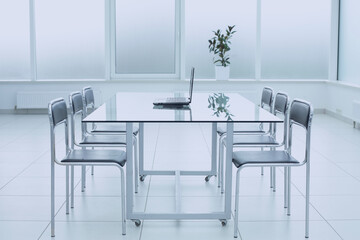Spacious, bright, modern office space. Glass table. A place to learn at work.