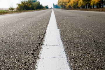 Old asphalt road. Driving on an empty road