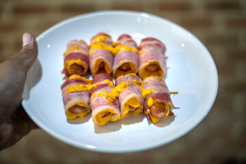 Bacon with Sausage and Cheese on the dish.