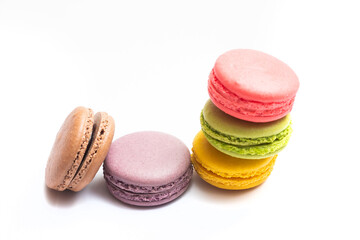 Fototapeta na wymiar Various flavors of pastel macarons stacked against isolated on white background. Macarons is a delicate meringue-based cookie sandwich It is a dessert of French origin.