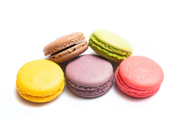 Bitten macaron and Various flavors of pastel macarons stacked against isolated on white background. Macarons is a delicate meringue-based cookie sandwich It is a dessert of French origin.