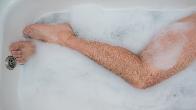 Funny Picture of a Man Taking a Relaxing Bath. Close-up of Male Feet in a  Bath with Foam and Rose Petals Stock Image - Image of petals, male:  210526457