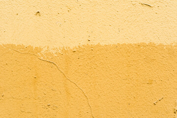 Painted in a yellow rough orange wall. Close up view