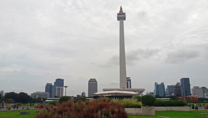 Visible from behind the entrance of the historical monas tour with a beautiful foreground of plants