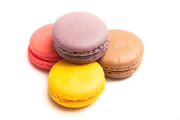 Various flavors of pastel macarons stacked against isolated on white background. Macarons is a delicate meringue-based cookie sandwich It is a dessert of French origin.