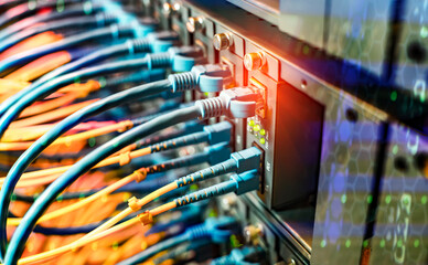 Fiber Optic cables connected to optic ports and Network cables connected to ethernet ports