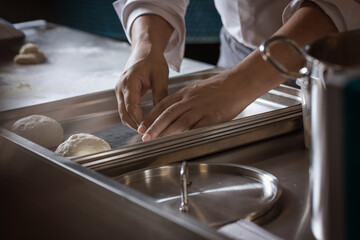 Making dough for bread by male hands in restaurant kitchen. Cooking concept.