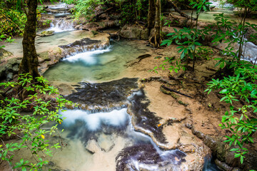 Waterfall and blue emerald water color in Erawan national park. Erawan Waterfall, Beautiful nature rock waterfall steps in tropical rainforest at Kanchanaburi province, Thailand
