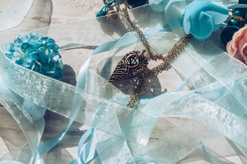 bronze nest pendant inside blue ribbons