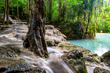 Waterfall and blue emerald water color in Erawan national park. Erawan Waterfall, Beautiful nature rock waterfall steps in tropical rainforest at Kanchanaburi province, Thailand