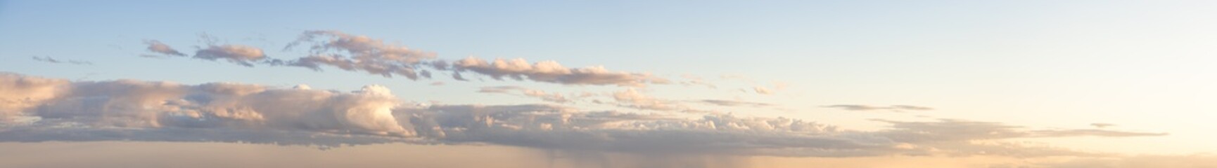 Panoramic View of Cloudscape with puffy sky and clear sunny sunlight during a colorful sunset or sunrise. Taken on the West Coast of British Columbia, Canada.