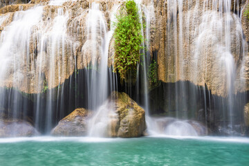 Waterfall and blue emerald water color in Erawan national park. Erawan Waterfall, Beautiful nature rock waterfall steps in tropical rainforest at Kanchanaburi province, Thailand