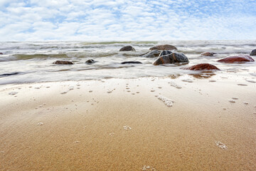 Baltic sea and sky. Big stone in the water - stormy weather.