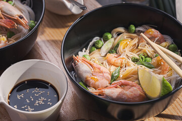 Asian dinner for two. Asian cuisine, rice noodles with seafood and vegetables