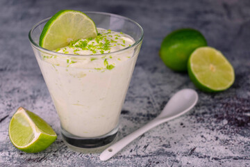 
Yogurt with lime and mint in a glass. Refreshing dessert.
Close-up.