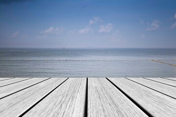 White wooden floor and sea and blue sky