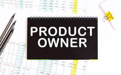 product owner. informationon on a black notebook, on a background office table.