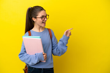 Student kid woman over isolated yellow background pointing finger to the side and presenting a...