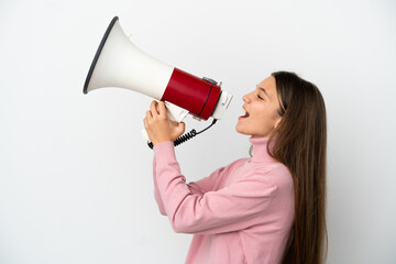 Little girl over isolated white background shouting through a megaphone to announce something in...