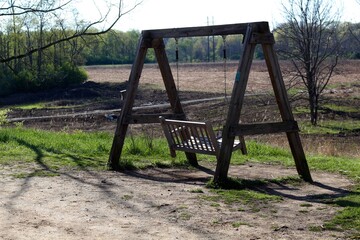 The empty wood swinging bench in the park.