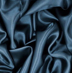 Smooth elegant dark grey silk or satin texture as abstract background. Luxurious background design