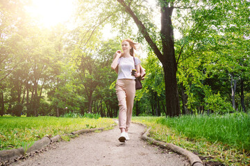 Emotional resilience, psychological ability to adapt to pressure, change and stress. Business woman enjoying life on the background of green trees in the park