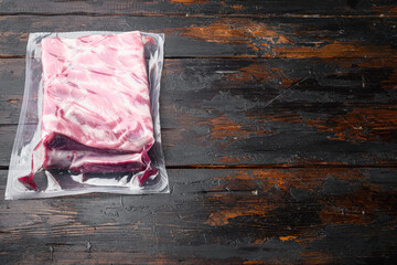 Sous vide vacuum pork rip food, on old dark  wooden table background, with copy space for text
