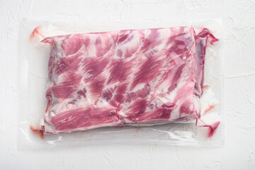 Fresh Pork rib in plastic pack, on white stone  background, top view flat lay