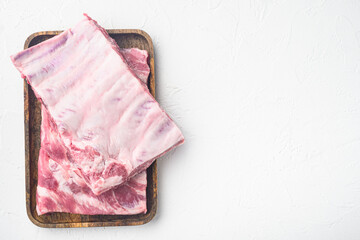 Pork rib, on wooden serving board, on white stone  background, top view flat lay, with copy space for text