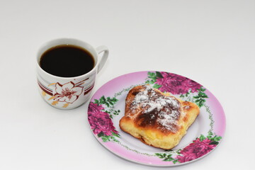 Croissants, branzoici,romanian  bakery products with 
 coffee-. romanian homemade donuts on a plastic plate with daisies