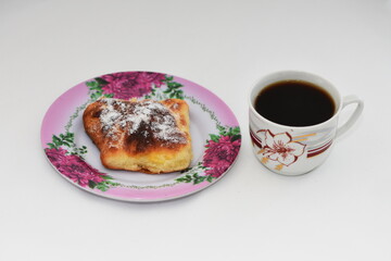 Croissants, branzoici,romanian  bakery products with 
 coffee-. romanian homemade donuts on a plastic plate with daisies