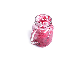 Empty dirty glass of berry smoothie isolated on white background.