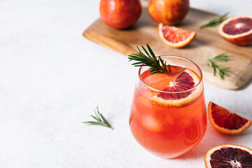 Delicious Blood Orange Cocktail on white table background. Summer cocktails, lemonade, refreshing drinks, low alcohol mocktail concept. Copy space, close up