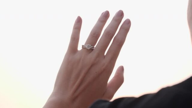 close up of women's hands with wedding ring