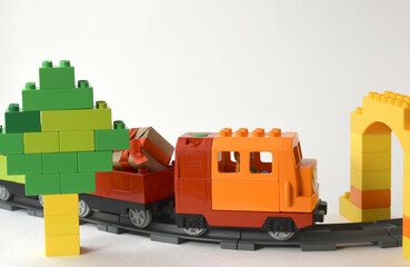 Close up kids toys composition with plastic toy train on railroad and tree. Childhood playing concept for preschool education or funny game. Copy space.